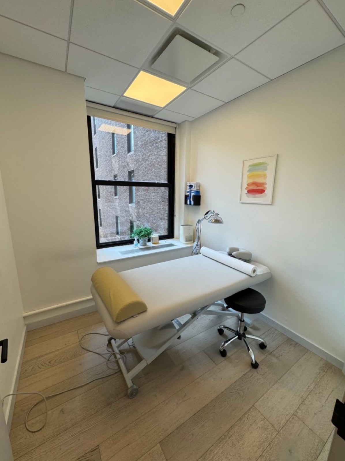 In-office procedure room at Robin Warner Neurology — exam table by a sunlit window, where EMG, Botox, and nerve-block procedures are performed